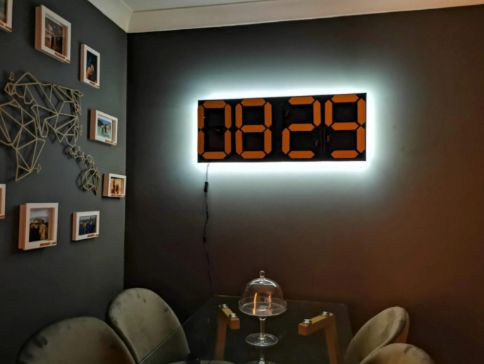 Electromechanical four-digit seven-segment clock displays the time silently